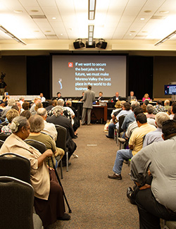 Woman inquiring about BERC services at an informational booth.